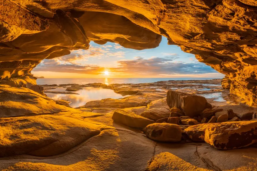 Central Coast Visitors Guide. looking out a cave that looks like map of Australia