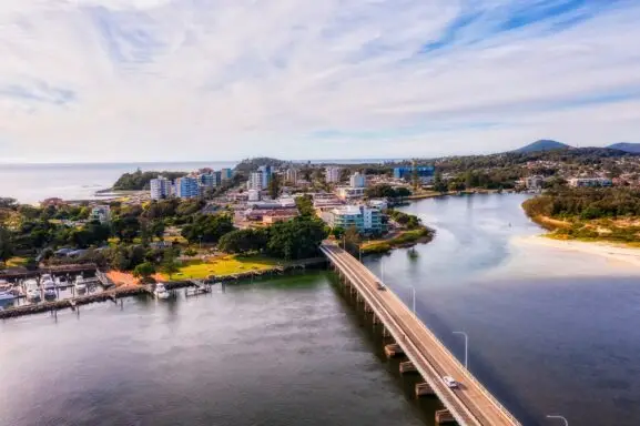 Forster Tuncurry. Downtown main streets in Forster town on Pacific coast of Australia from bridge across Wallis lake - aerial view.