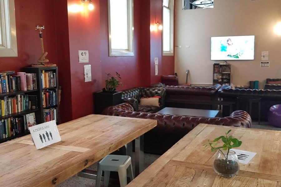 Entertainent and dining room with lounges, tables and television to watch movies at Big Backpackers Hostel