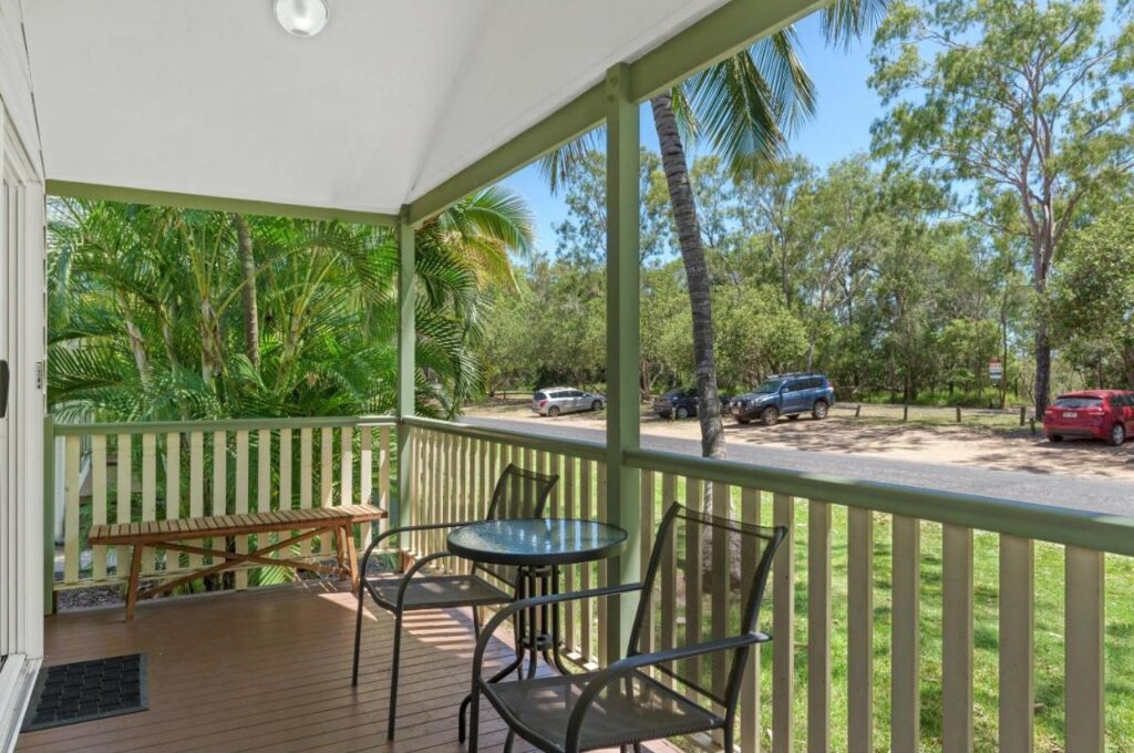 A view from the deck at one of the cabins lookin out towards lush trees and plants at Discovery Parks Tannum Sands