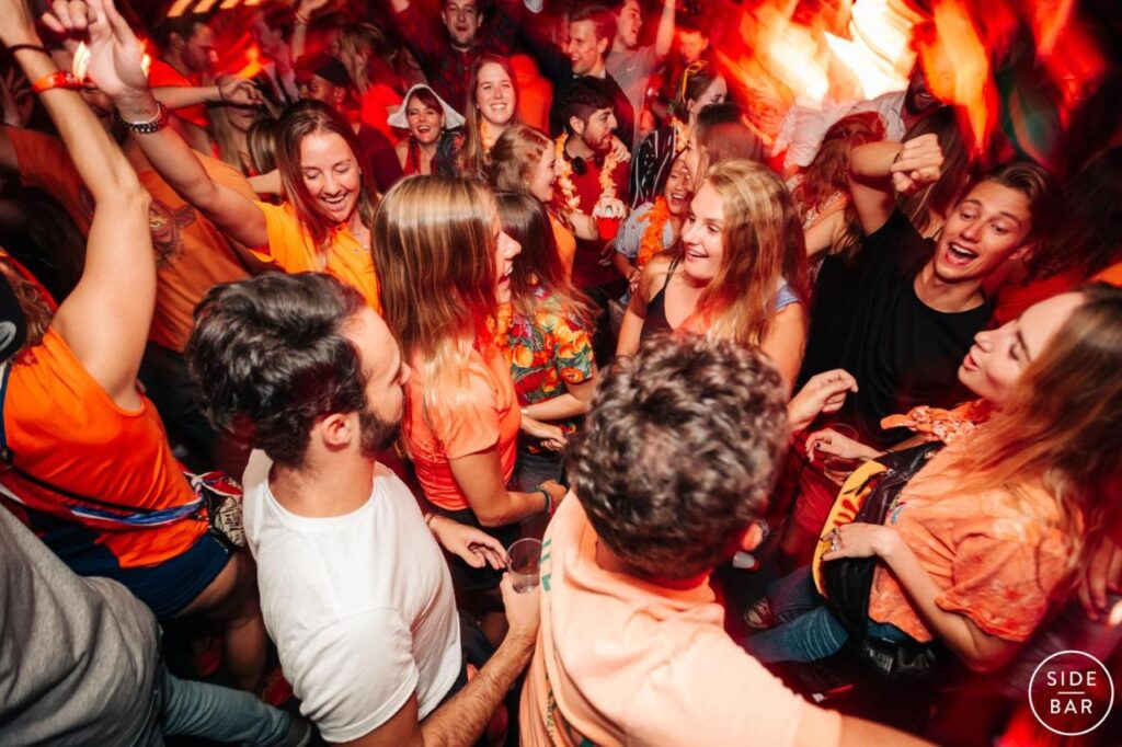 A bunch of travellers danince into the night at Side Bar near Hostel Wake Up! Sydney Central