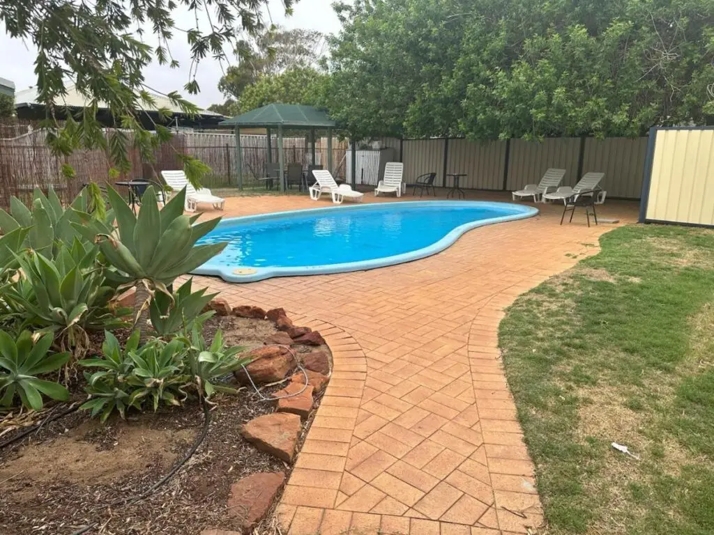 Relax in a swimming pool while resting in the Western Australian sun at Kalbarri Backpackers Hostel