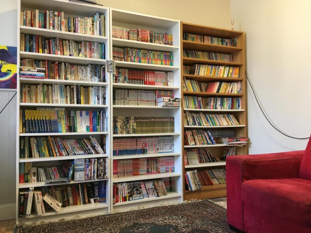 Plenty of books to read and share in a cosy room while staying at Shingo's Backpackers