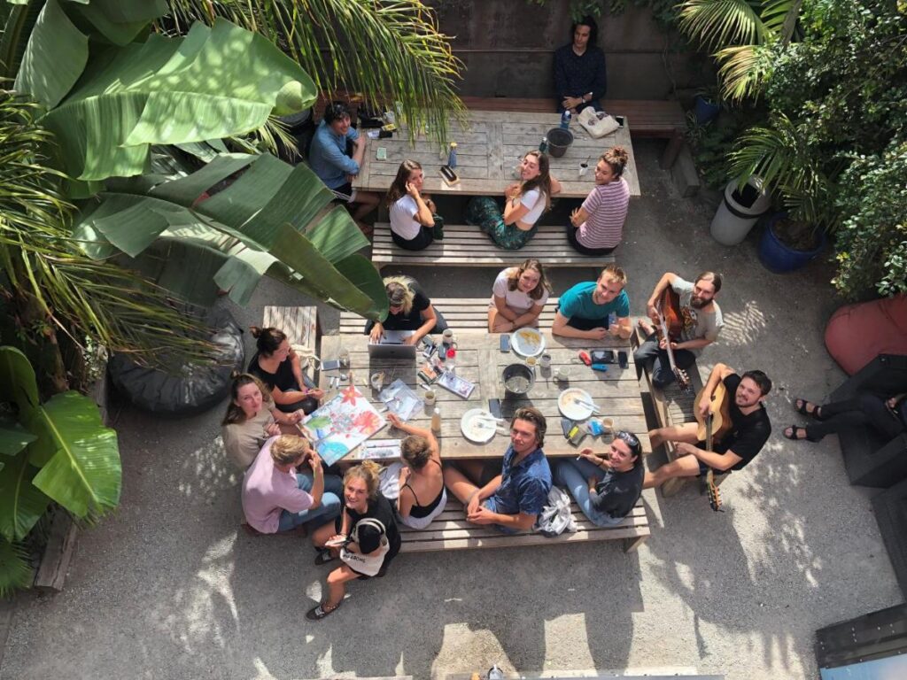 Travellers socialising in the outdoor space at The Nunnery Accommodation