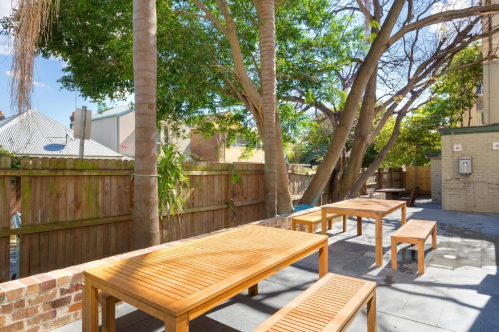 Outdoor dining area for travellers to relax and enjoy the sunshine at The Village Glebe