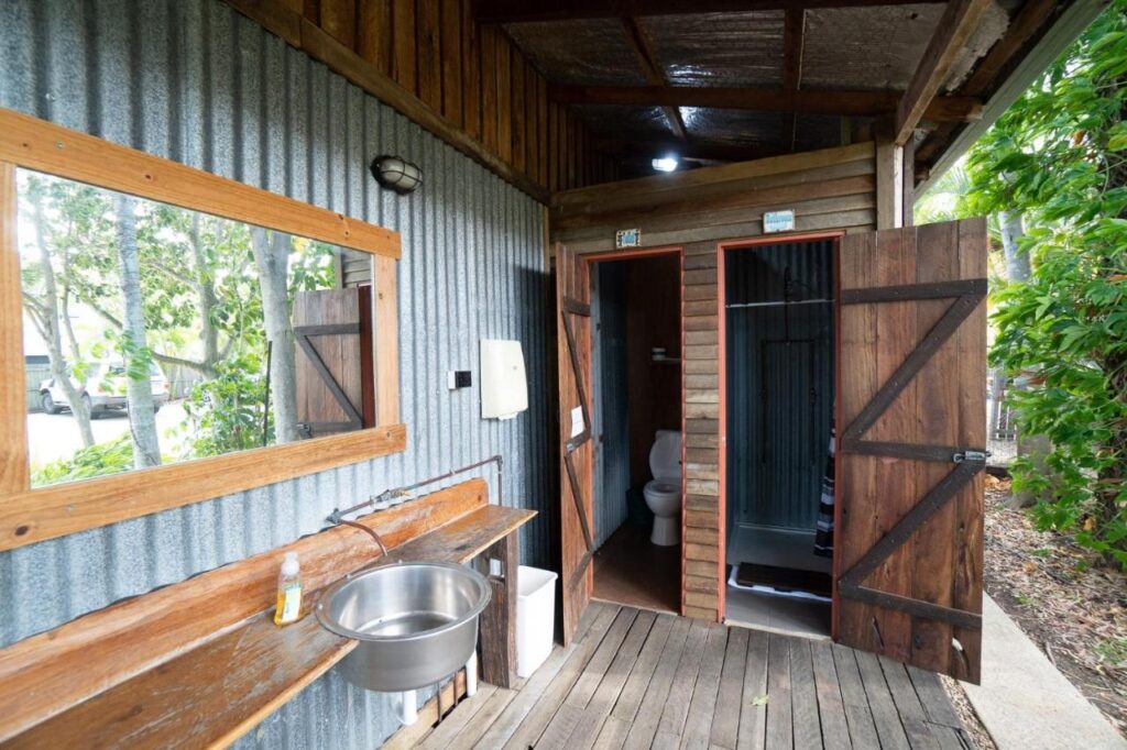 Outdoor shared bathrooms located in the outdoor area at Woolshed Eco Lodge