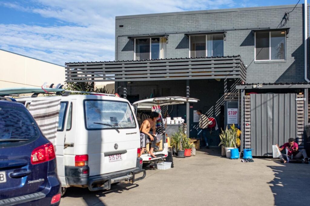 A parking stace and street view where travellers can meet to catch the shuttle to the airport or park their vans and cars when staying for the night at Woopi Backpackers