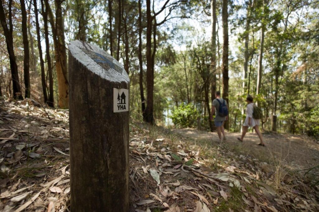 A couple of travellers on the walk toward the YHA Pittwater Eco Sydney