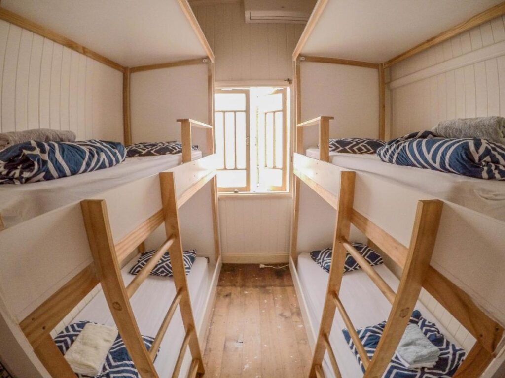 A bright and airy four bed dormitory at Bunk Inn Hostel