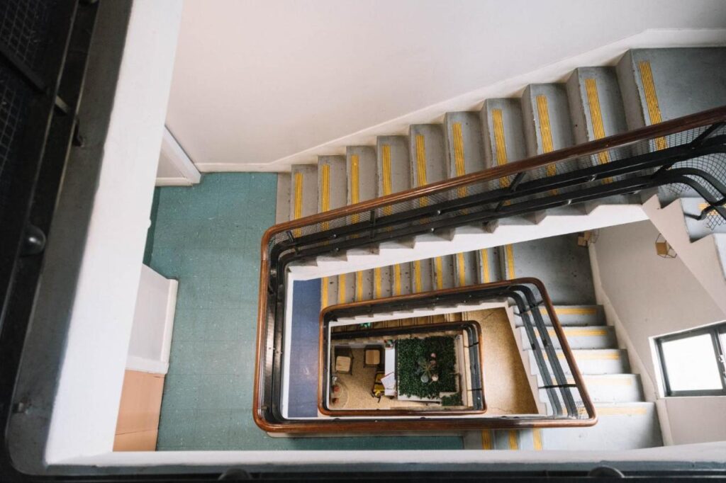 The stairwell showcasing the number of five floors at the Carric Hostel