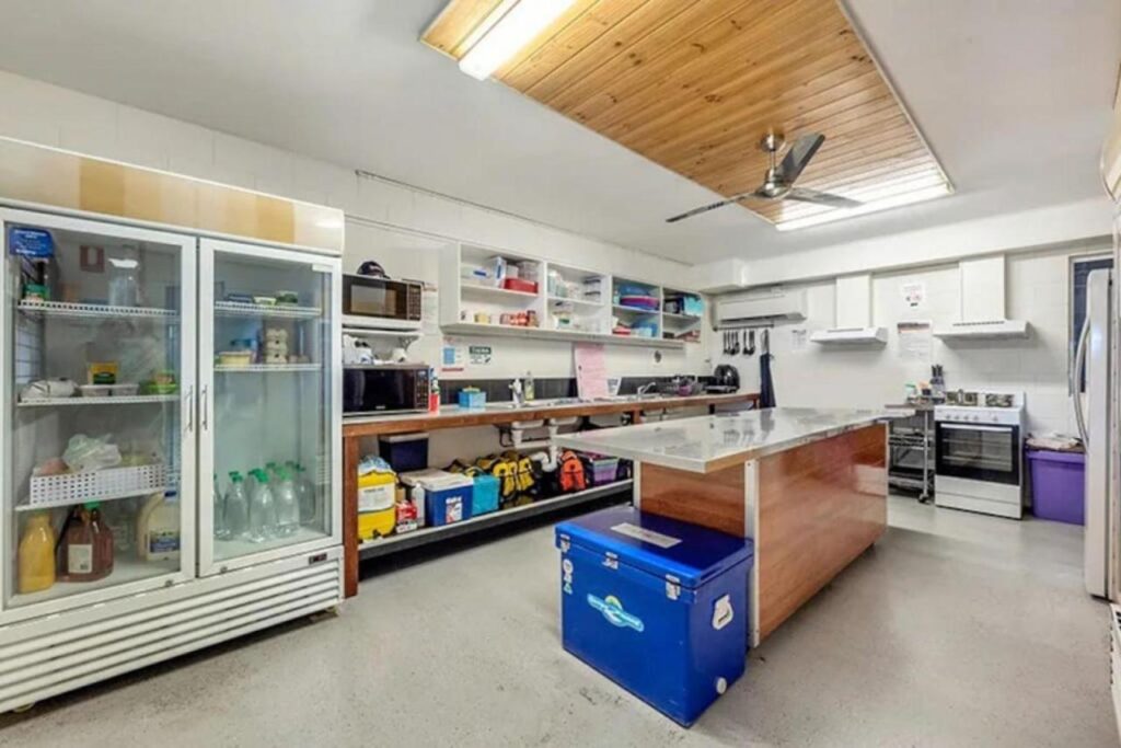 Shared kitchen space for travellers to cook their own meals at Seaside Lodge Hostel Townsville