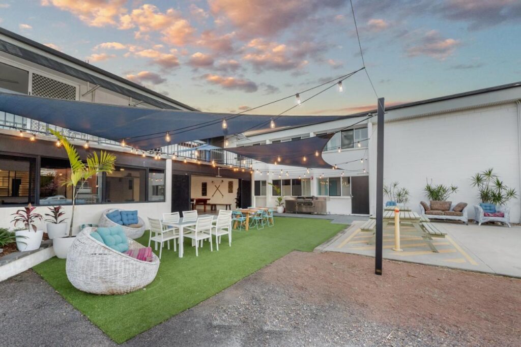 The outdoor entertainment area with plenty of things to do and spaces to chat and meet other guests at Seaside Lodge Hostel Townsville