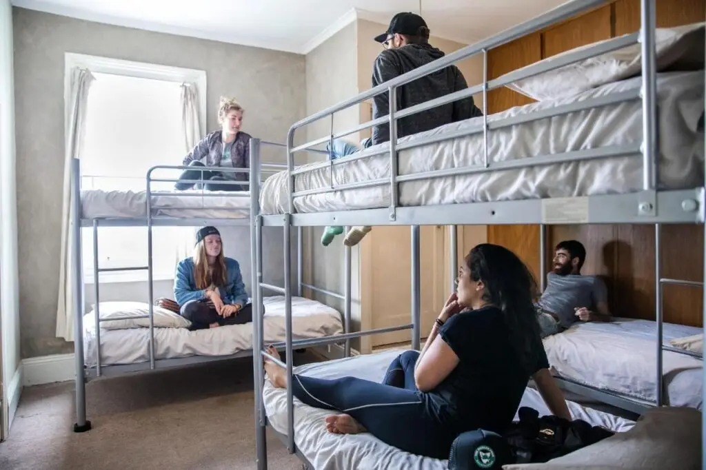 The dormitory with travellers and guests getting to know eachother while reslaxing on their bung beds at The Pickled Frog Hostel.