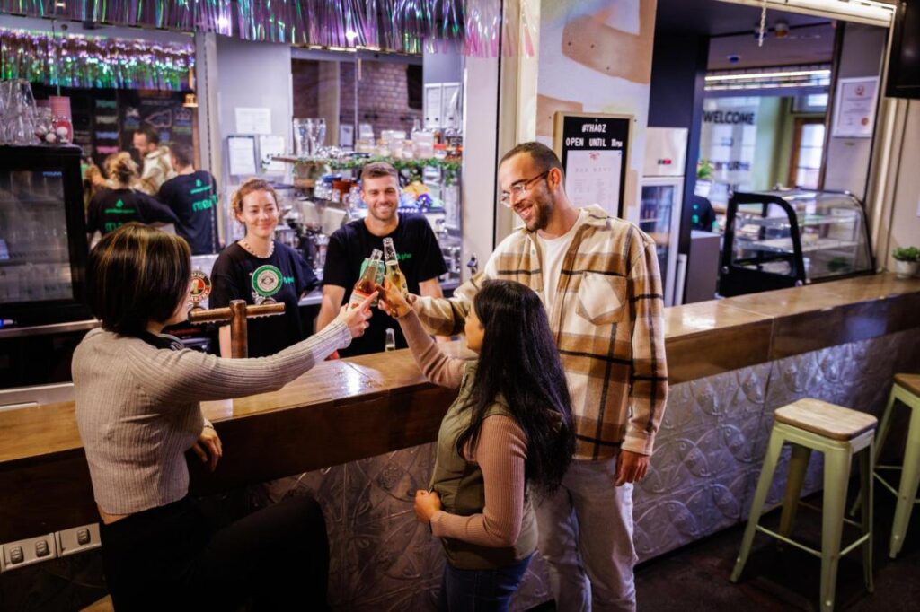 A few travellers enjoying a drink at the bar in YHA Melbourne Central