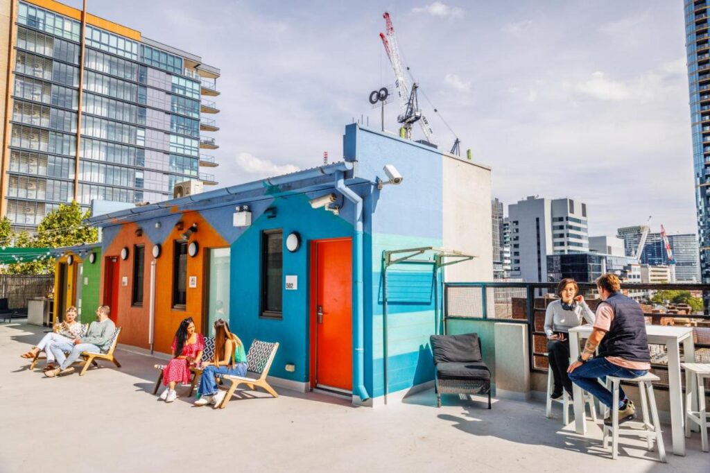 Travellers chilling out and looking over the views of Melbourne city at YHA Melbourne Central