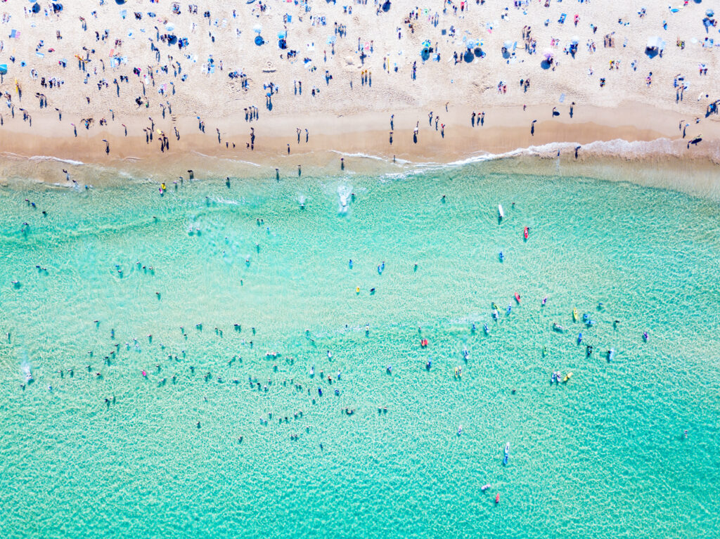 Bondi Beach New South Wales aerial view on a perfect summer day with people swimming and sunbathing. Bondi is one of Sydney’s busiest beaches and is located on the East Coast of Australia