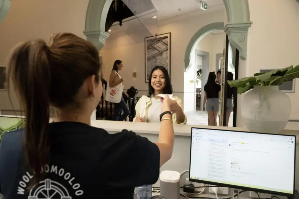 Friendly staff assisting a traveller in booking and checking-in at The Pacific House.